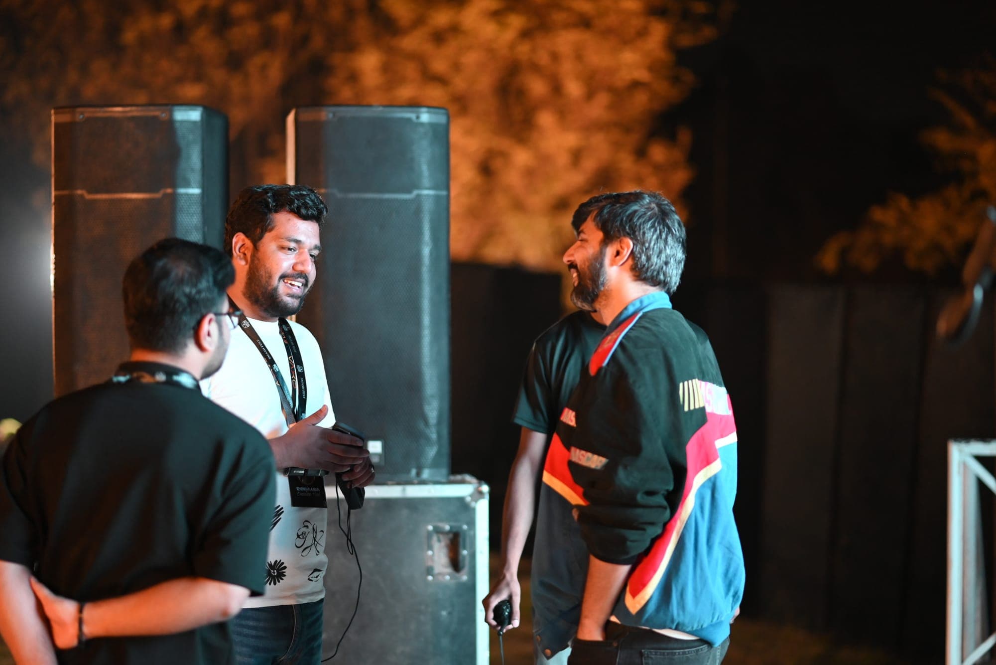 Crew members laughing together between sets at SMASH FEST Season 1