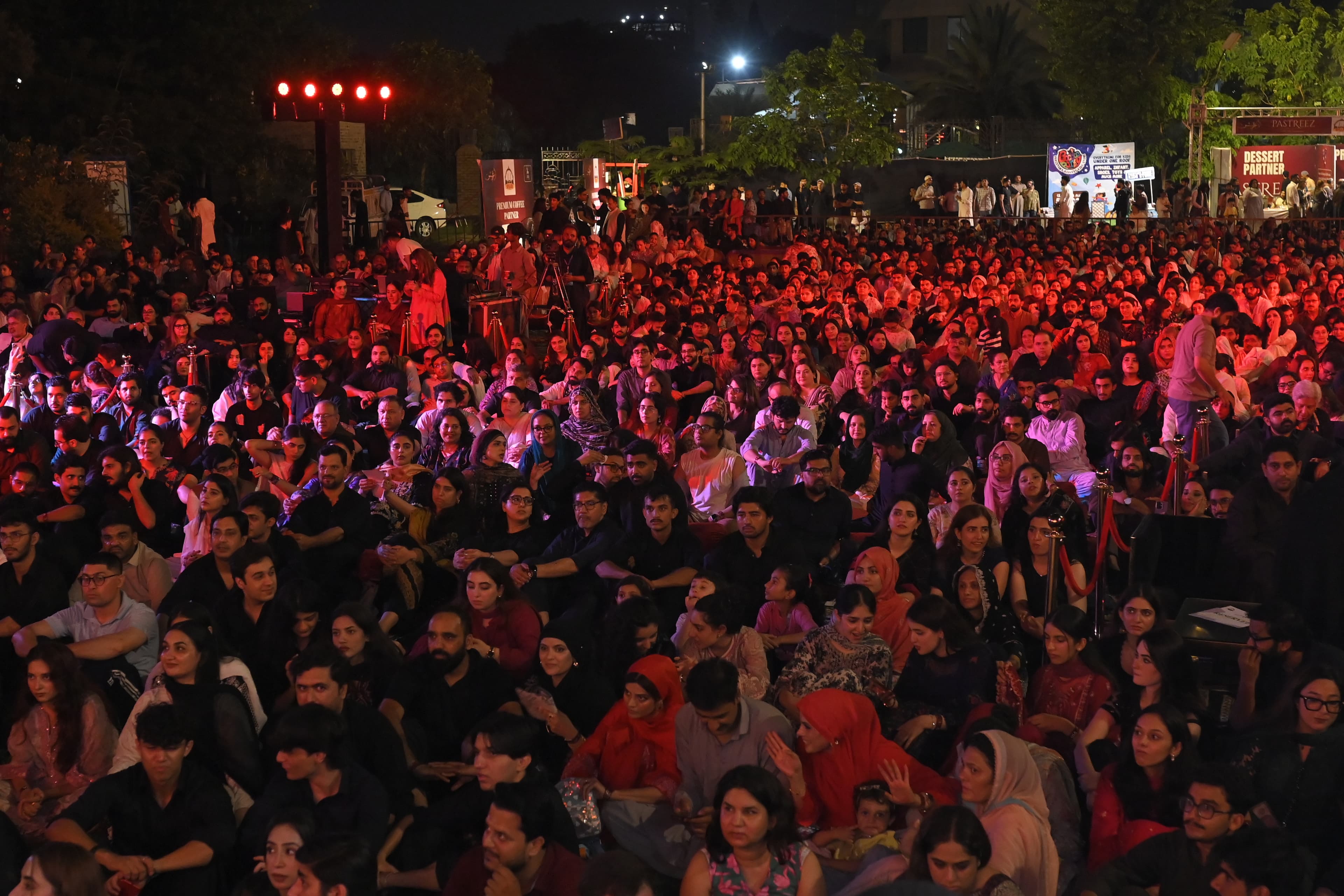 A massive crowd bathed in red stage light at SMASH FEST Season 2